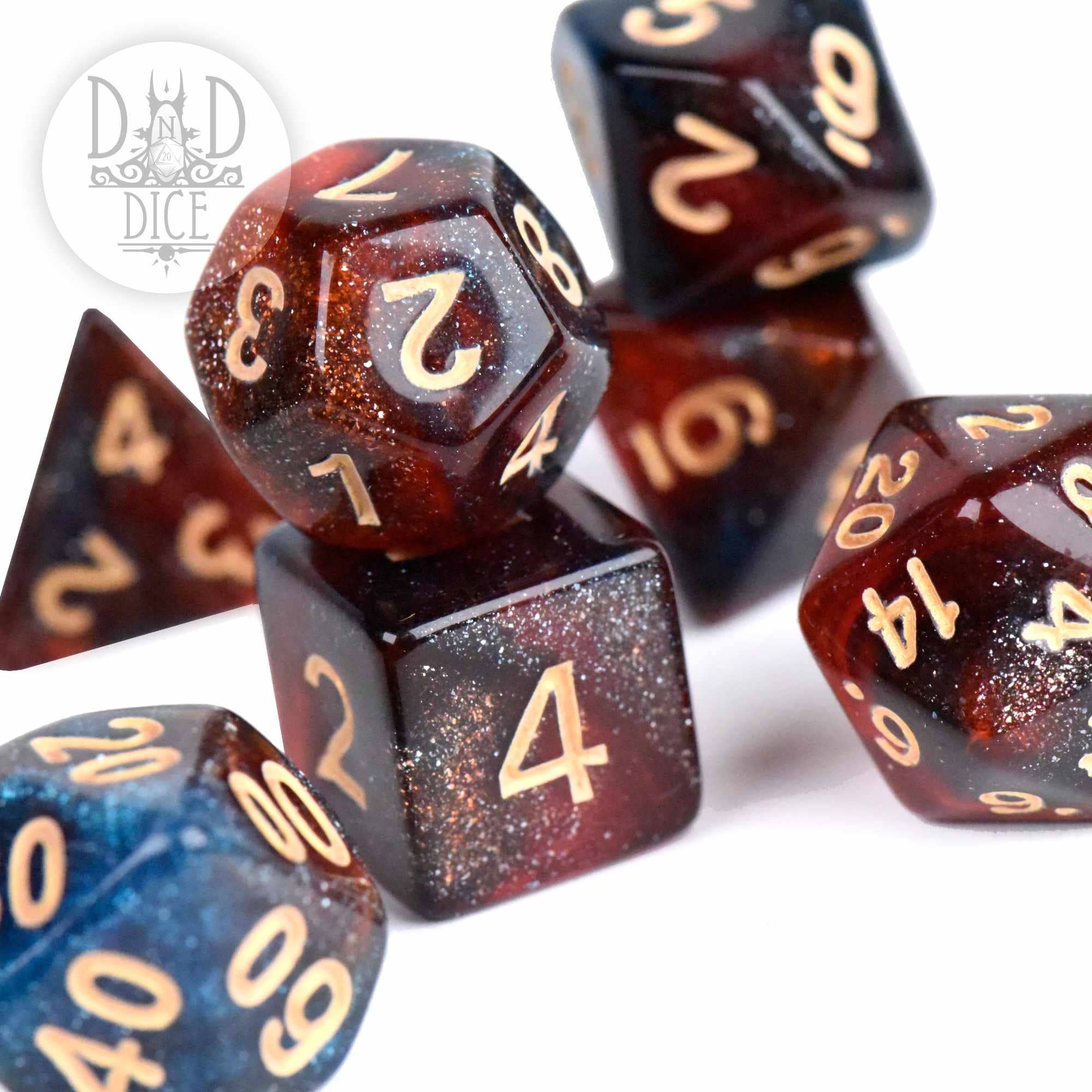 Elysium 7-dice set in glittery red and blue acrylic with gold numbers.