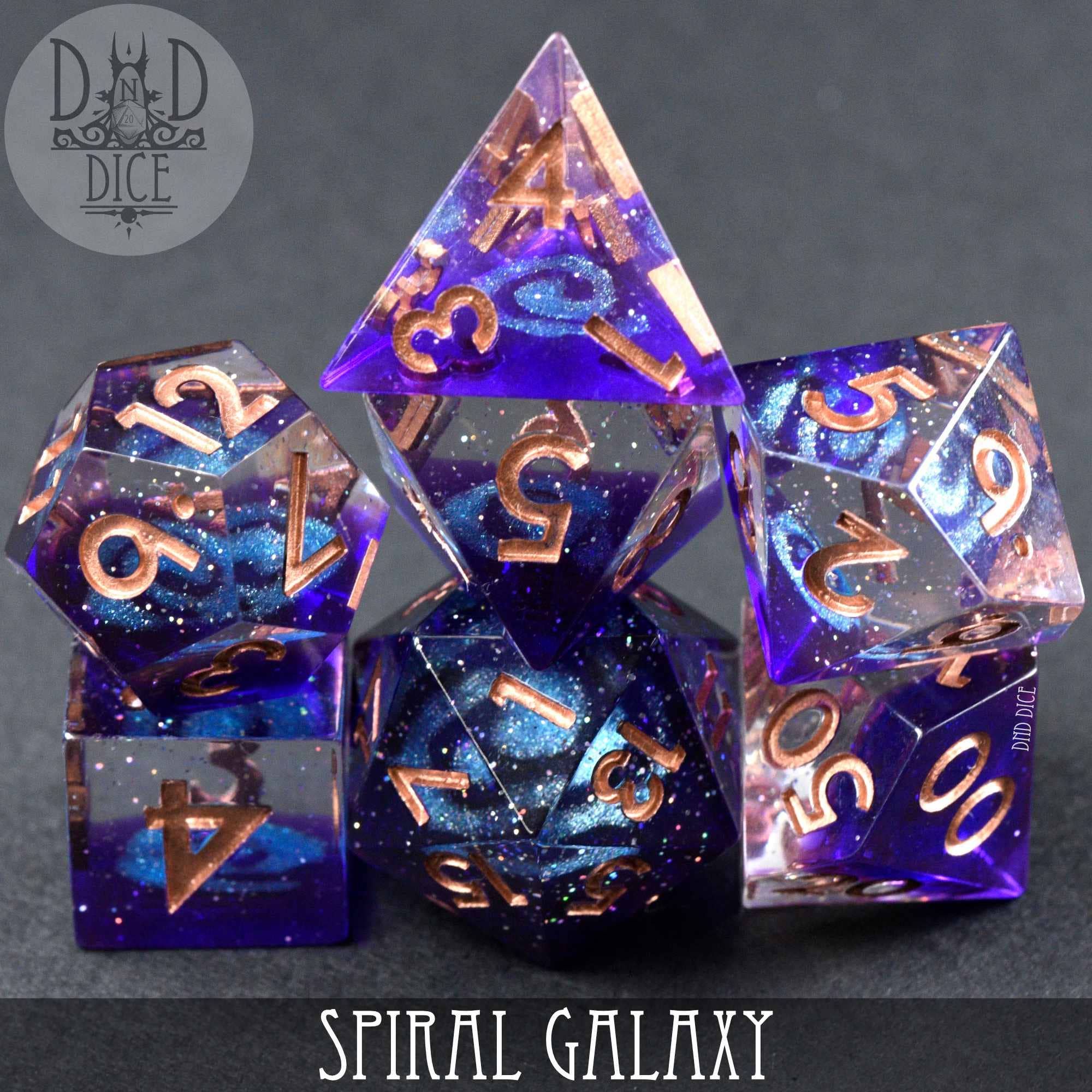 Spiral Galaxy Handmade 7-dice set in blue-purple glitter resin with copper numbers.