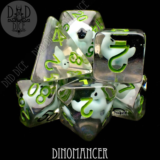 Dinomancer 7-dice set: clear resin dice featuring green numbers and small white dinosaurs inside.