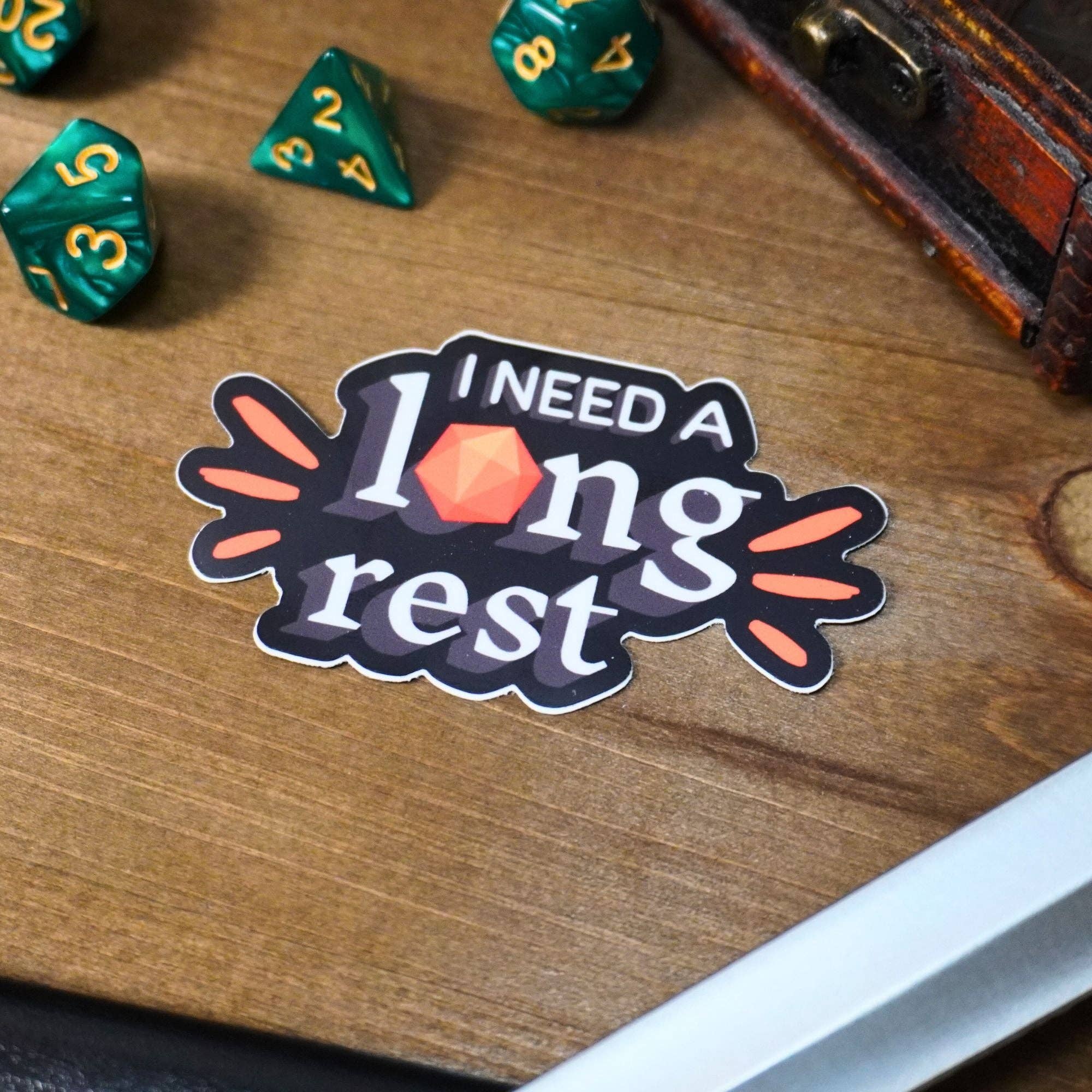 I Need a Long Rest sticker with text and a red D20 die used as the letter o.