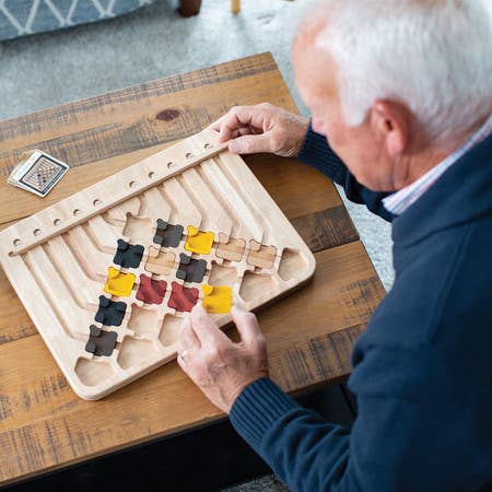 Marble Circuit Deluxe logic puzzle with colorful pieces arranged on a wooden game board.