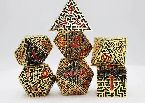 Egyptian Labyrinth RPG Metal Dice Set with gold and black designs and red numbers.