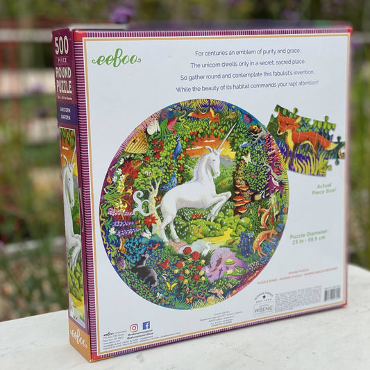 The Unicorn Garden 500 Piece Round Puzzle with a unicorn in a colorful, enchanted garden.