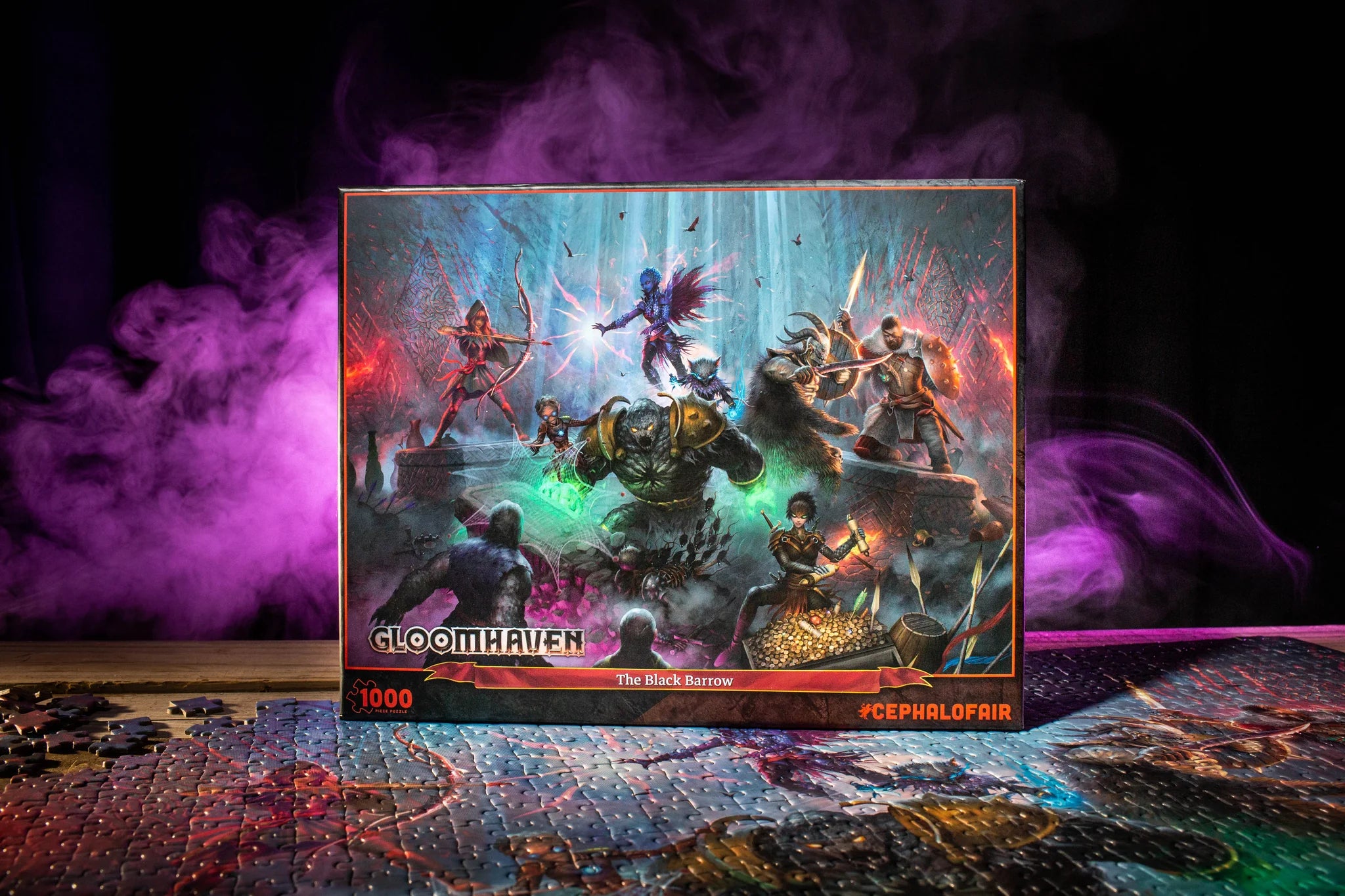 Gloomhaven 1000-piece Puzzle: The Black Barrow on top of a completed board game, with purple smoke in the background.