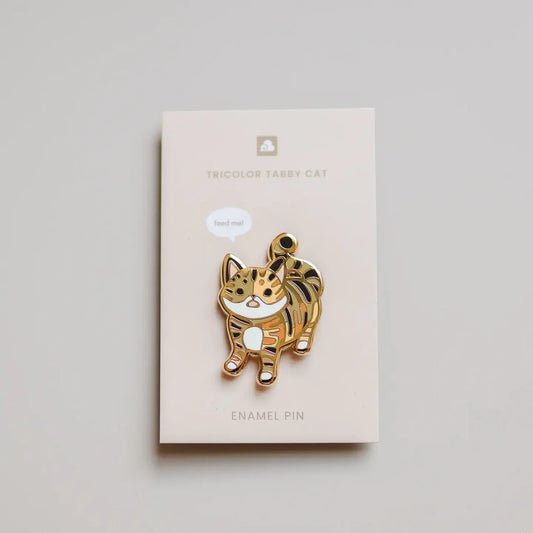 Tricolor Tabby Cat Enamel Pin showing a tricolor tabby cat, attached to a product name card.