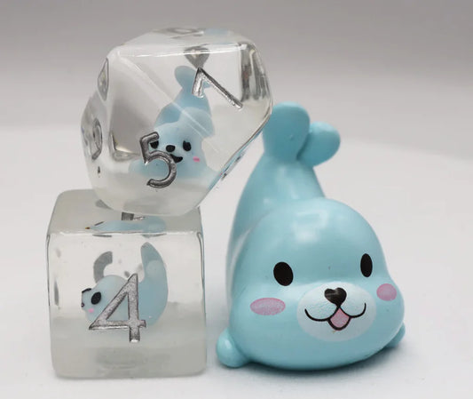 Blue Seal RPG Dice Set with two clear resin dice containing blue seal figures, shown next to a small blue seal toy.