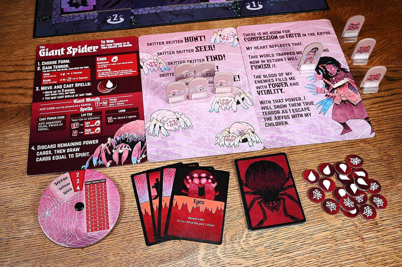 Vast: The Mysterious Manor board game cards, tokens, and spider art components on a table.