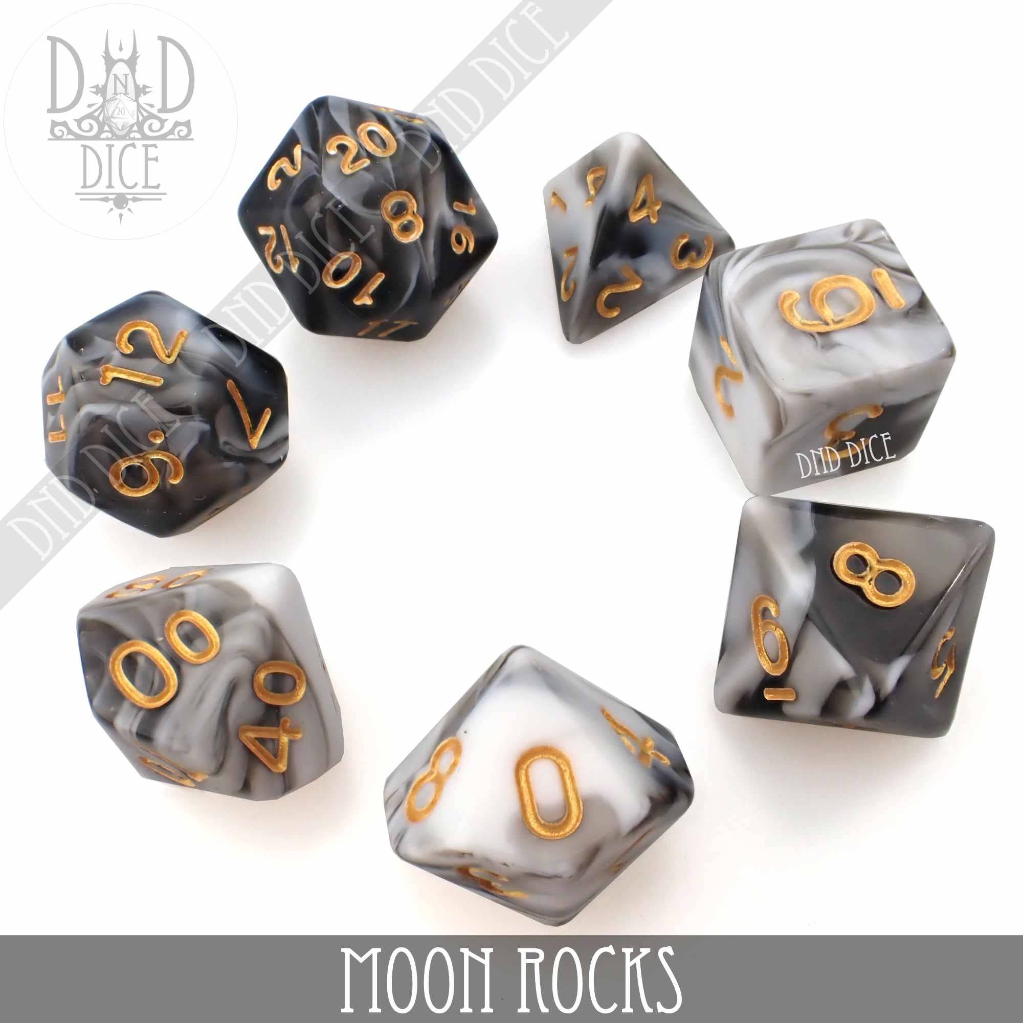 Set of 7 marbled black, white, and gray polyhedral dice with gold numbers, Moon Rocks 7 or 11 variant, in acrylic bottle.