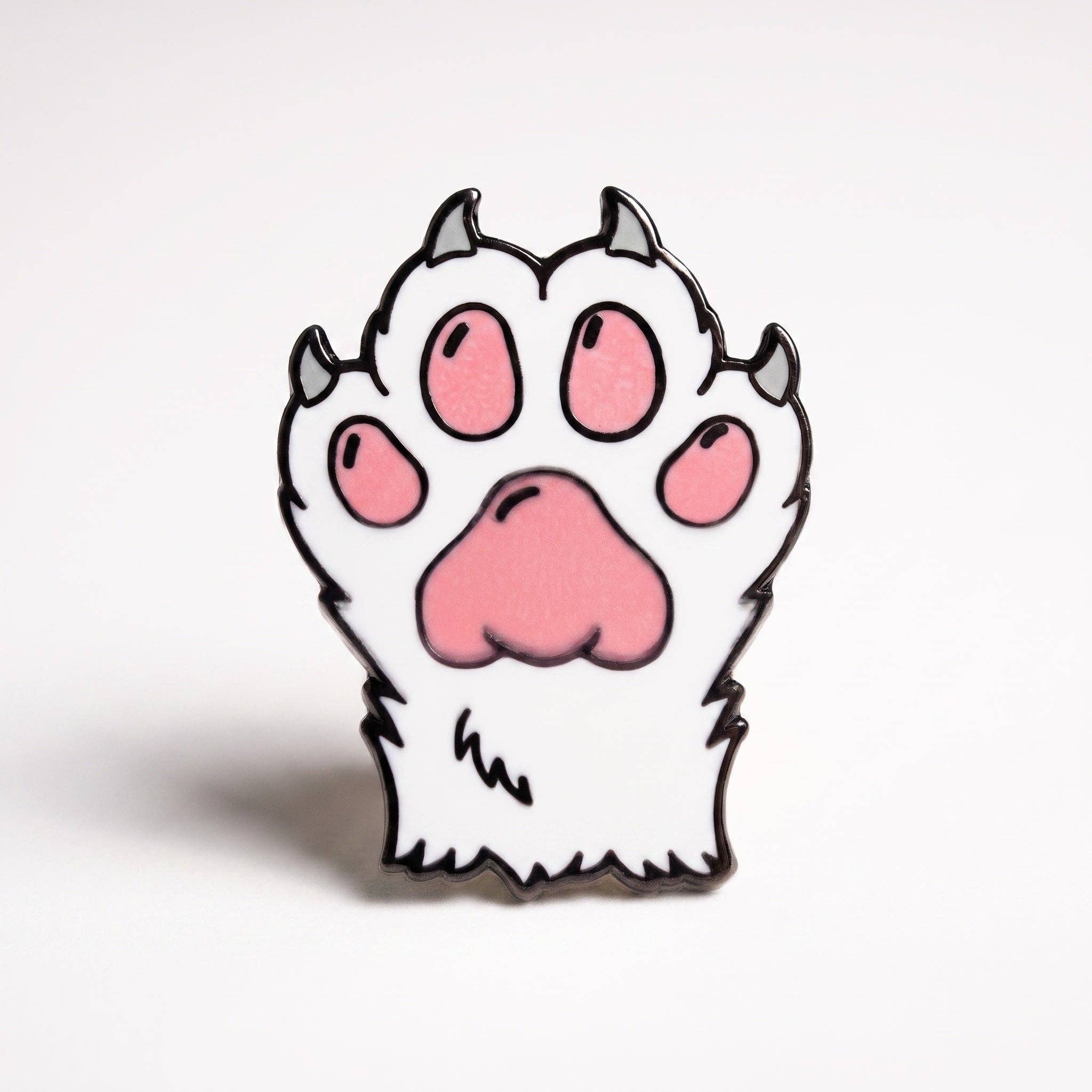 White kitten paw pin with pink pads, dark claws, and black plating.