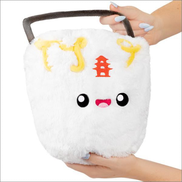Mini Comfort Food Takeout Box plush with yellow stitching, red pagoda design, and a face, shown held in a hand.