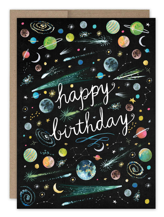 Birthday card with happy birthday in cursive, planets, stars, and comets on a black background.