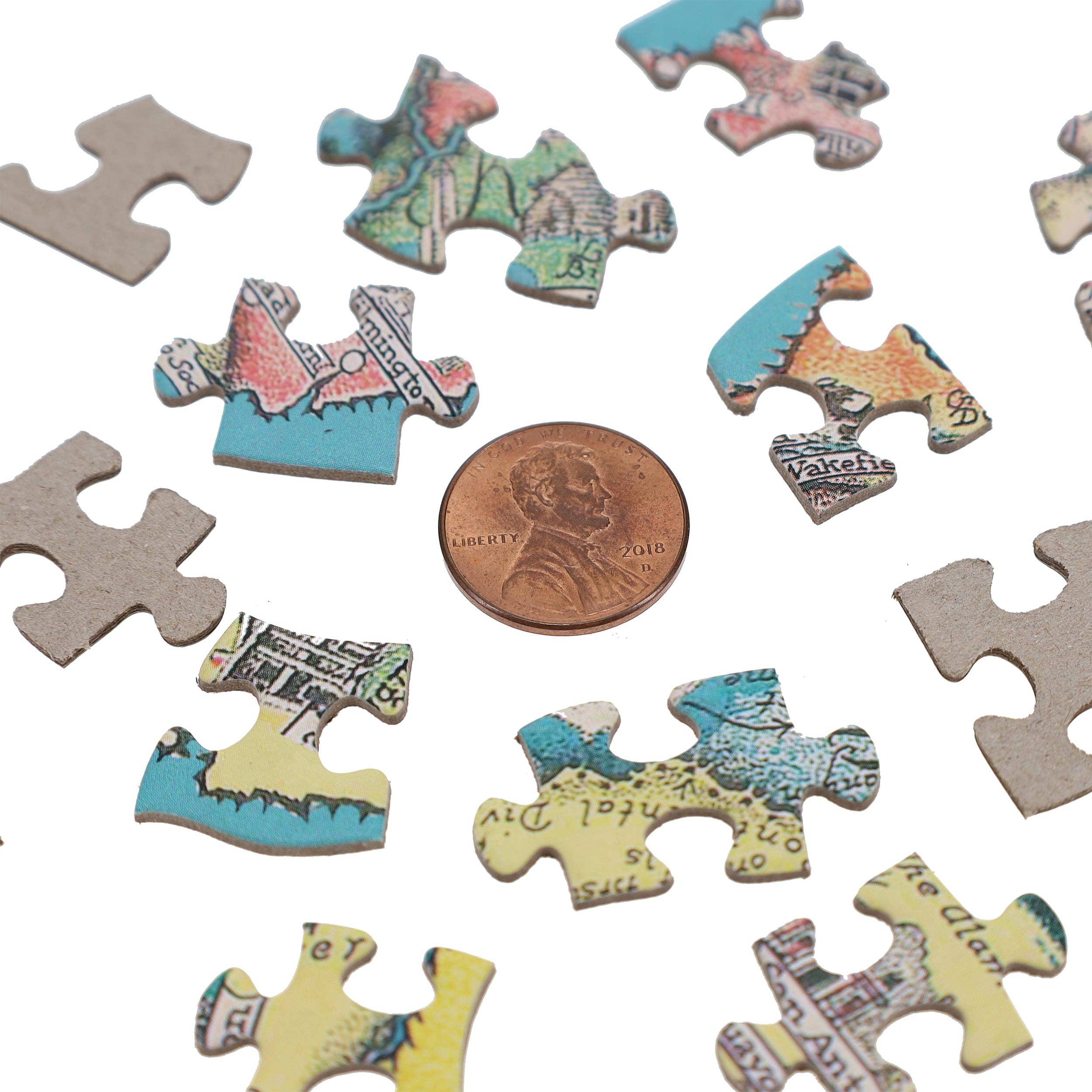 America the Wonderland Jigsaw Puzzle, 1,000 pieces with historical map designs, shown next to a penny for scale.