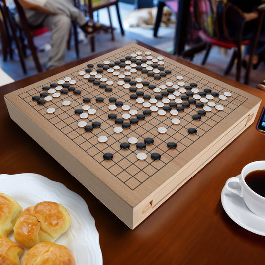 Wood GO Set, 12 in., with stones and drawers on a table next to pastries and coffee.