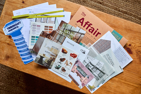Escape Room | Puzzle Game | Board Game | The Affair on a wooden table with magazines and design samples.