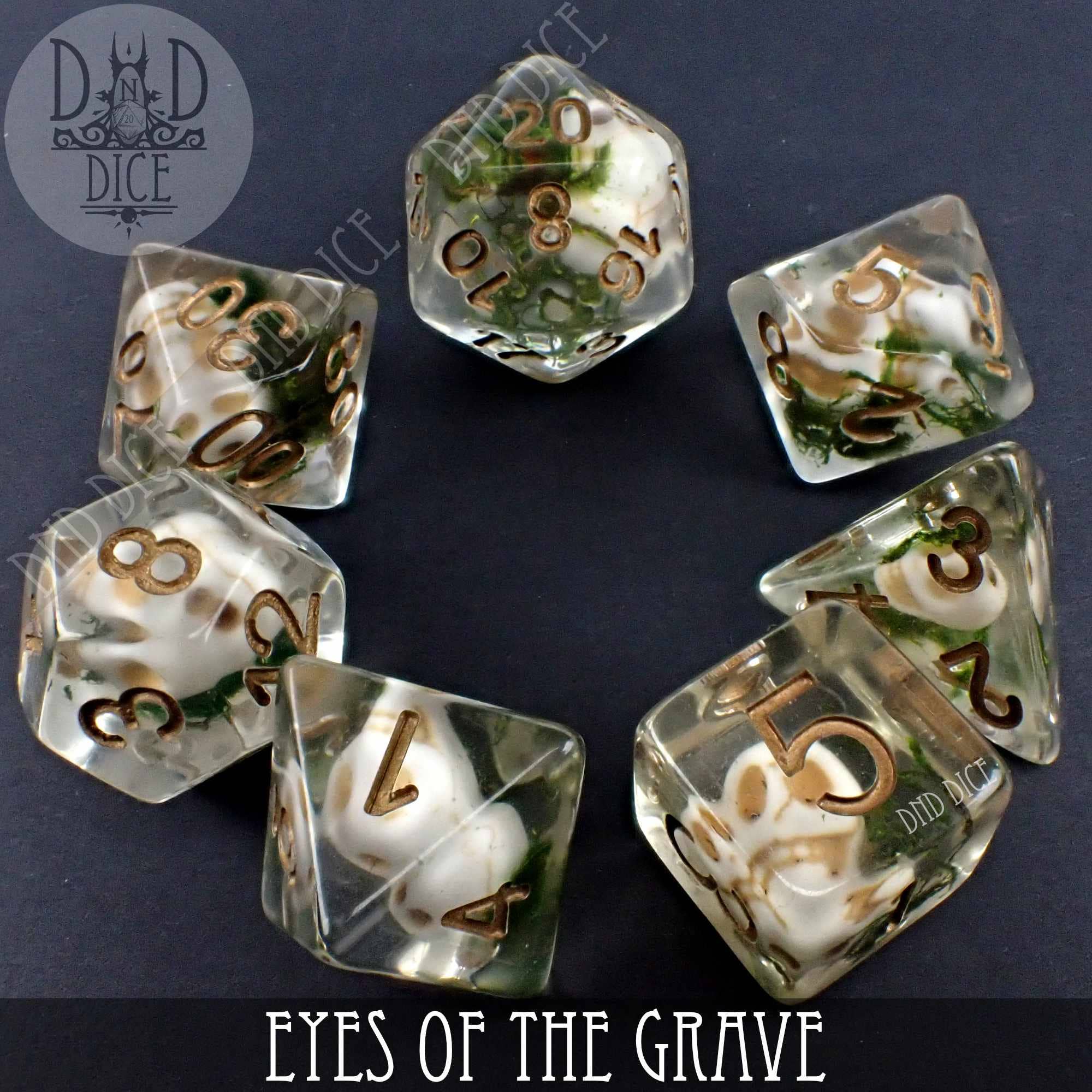 Eyes of the Grave 7-piece clear resin DnD dice set with small skulls embedded inside each die.