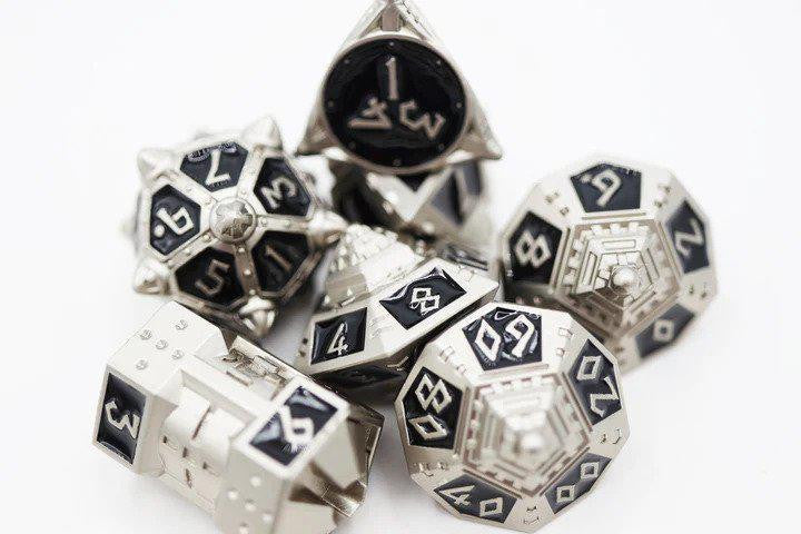 The Dice 51: Onyx Ethers RPG Metal Dice Set by Foam Brain, black and silver, displayed on a white surface.