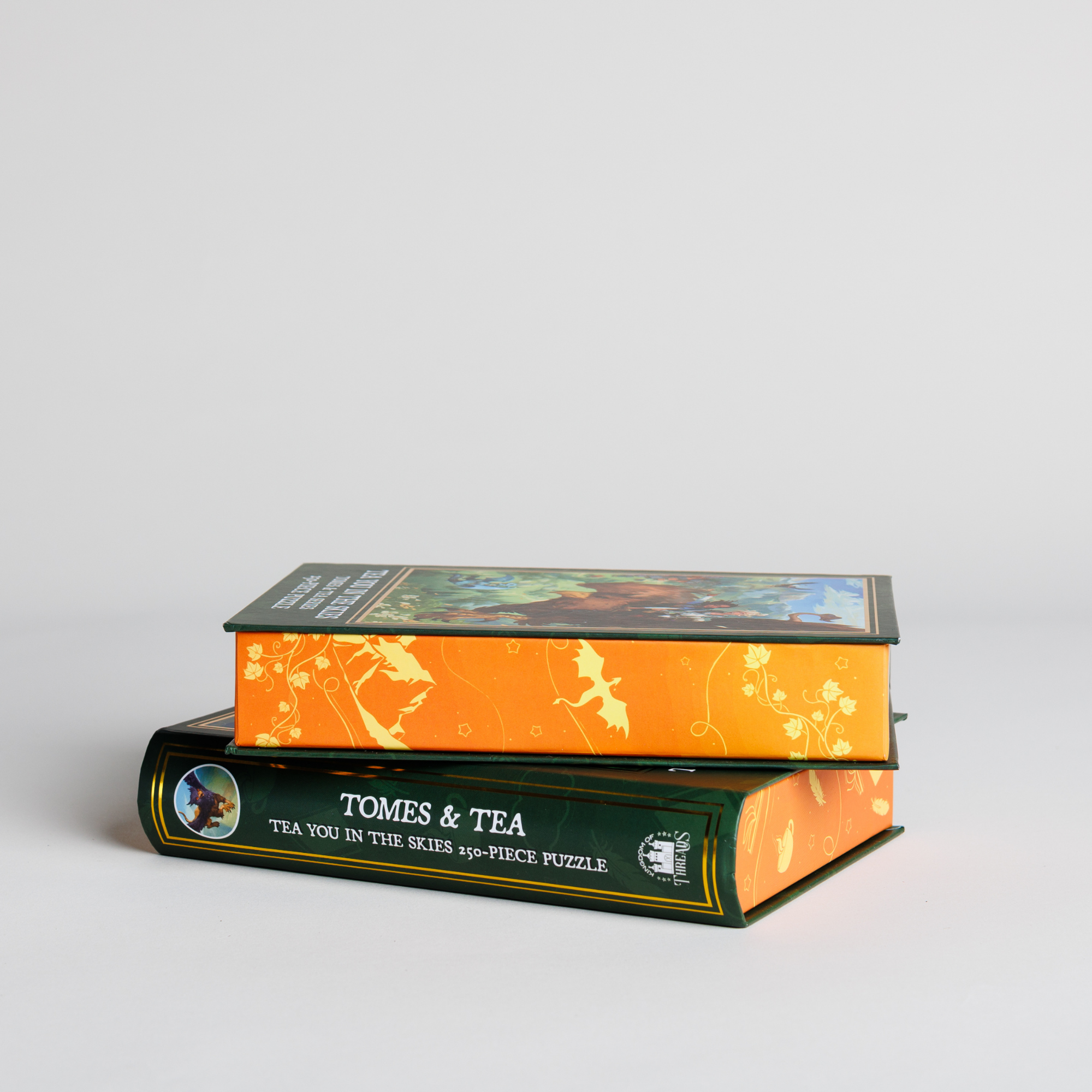 Tea You in the Skies Keepsake Puzzle by Tomes & Tea, packaged in two colorful boxes on a white surface.