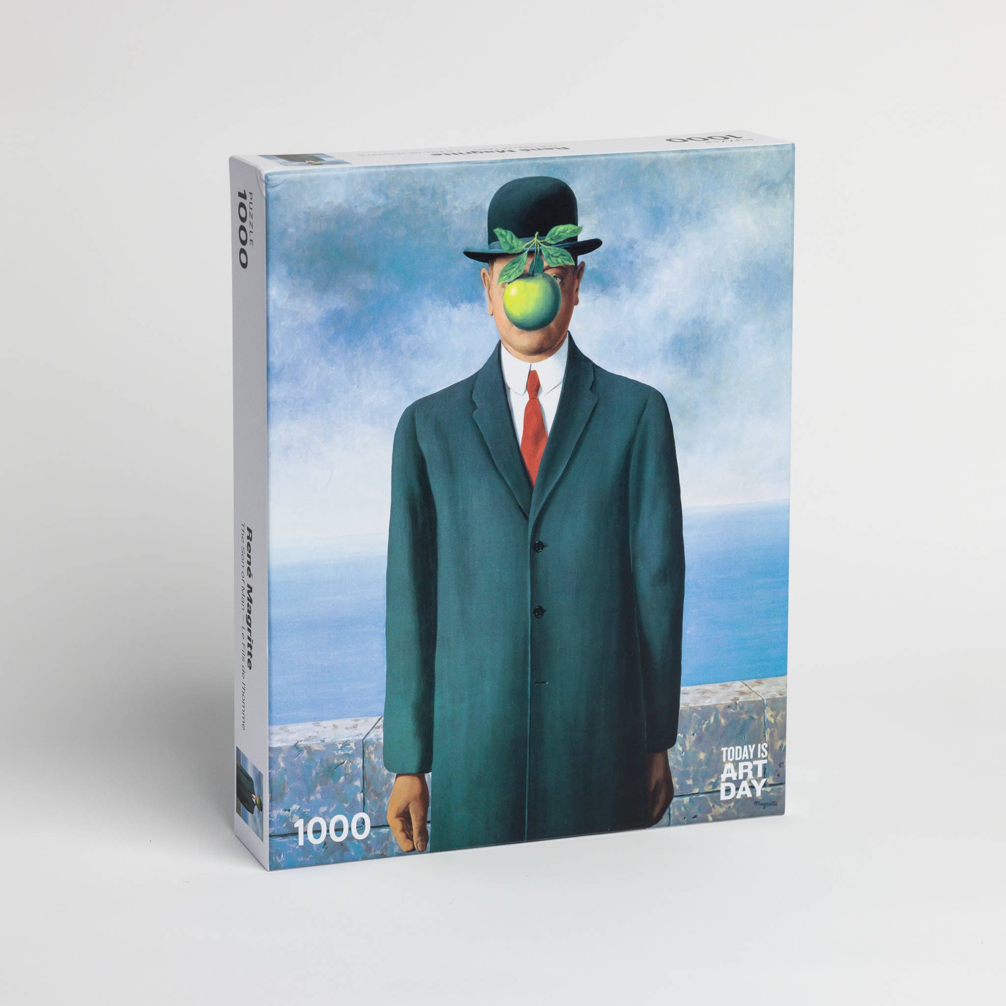1000-piece jigsaw puzzle of René Magrittes Son of Man featuring a man in a suit with an apple covering his face.