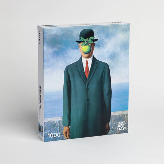 1000-piece jigsaw puzzle of René Magrittes Son of Man featuring a man in a suit with an apple covering his face.