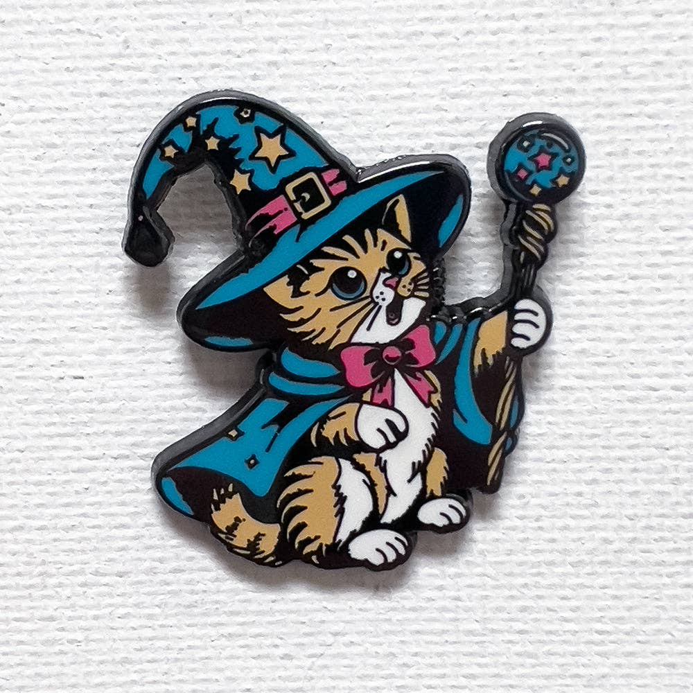 1.25-inch hard enamel tabby cat pin wearing a blue wizard hat and cape, holding a magical staff.