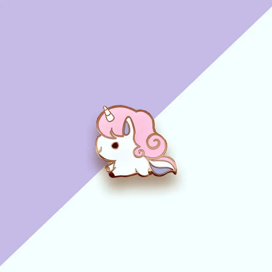 Pink Unicorn Enamel Pin with a pink-maned unicorn. Background is split purple and light blue.