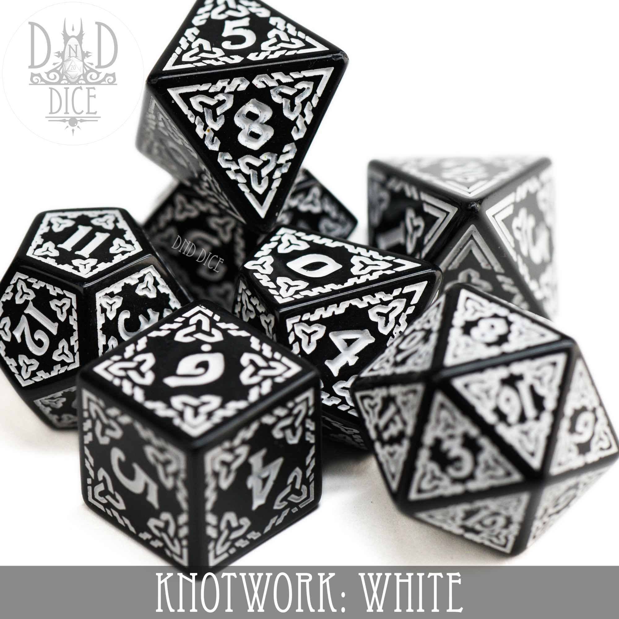 Knotwork: White 7-dice set, black acrylic with white knotwork and a teardrop-shaped D4 design.