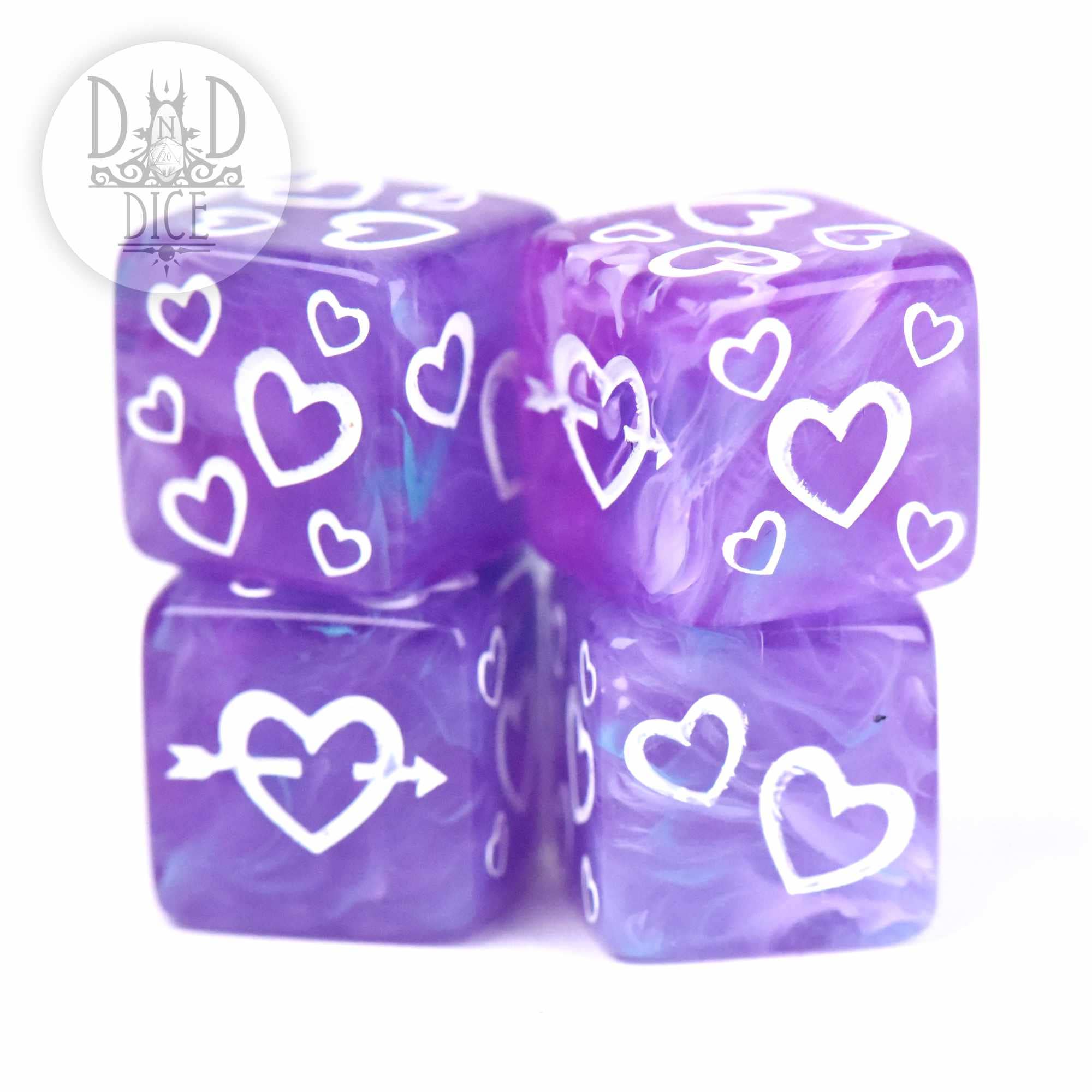 Emotional Damage 4D6 Set: four purple resin dice with white hearts, stacked on a white background.