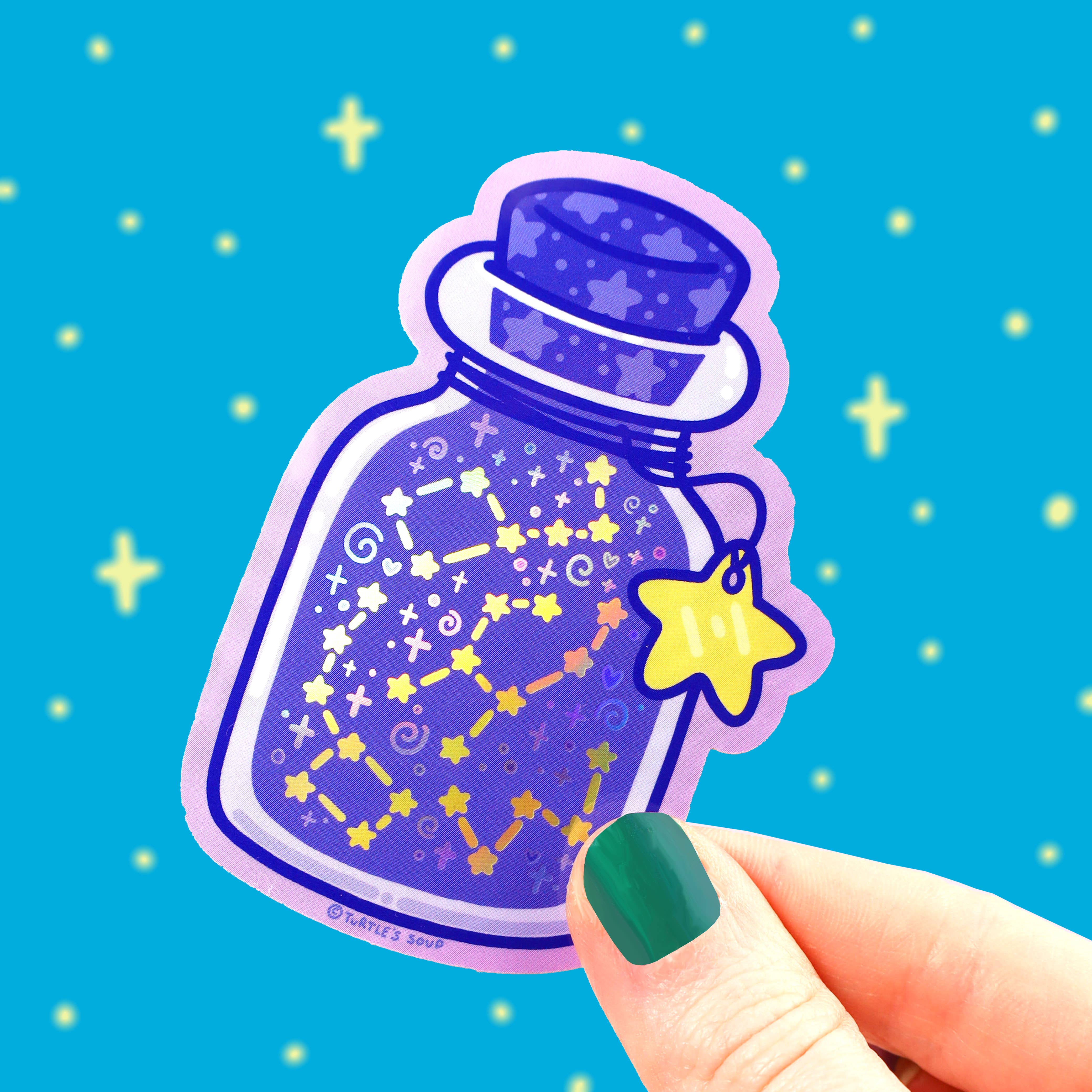 Hand holds the Bottle of Stars Astronomy Space Vinyl Sticker, holographic variant.