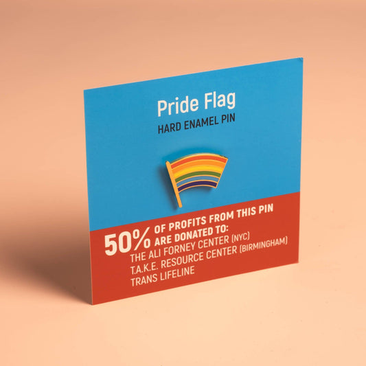 Pride Flag Pin displayed on card; 50% of profits support LGBTQ+ charities.