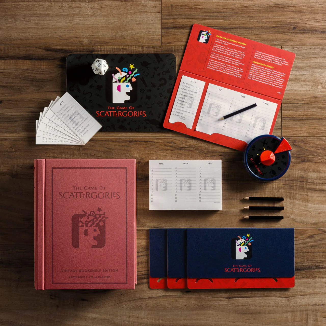 Scattergories Vintage Bookshelf Edition with cards, dice, timer, answer sheets, and pens on a wooden surface.