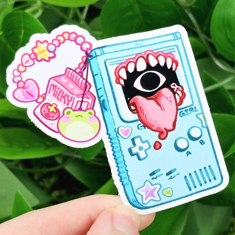 Two waterproof stickers: one with a milk drink and charms design, one with a Creepy Game Console Stickers design.