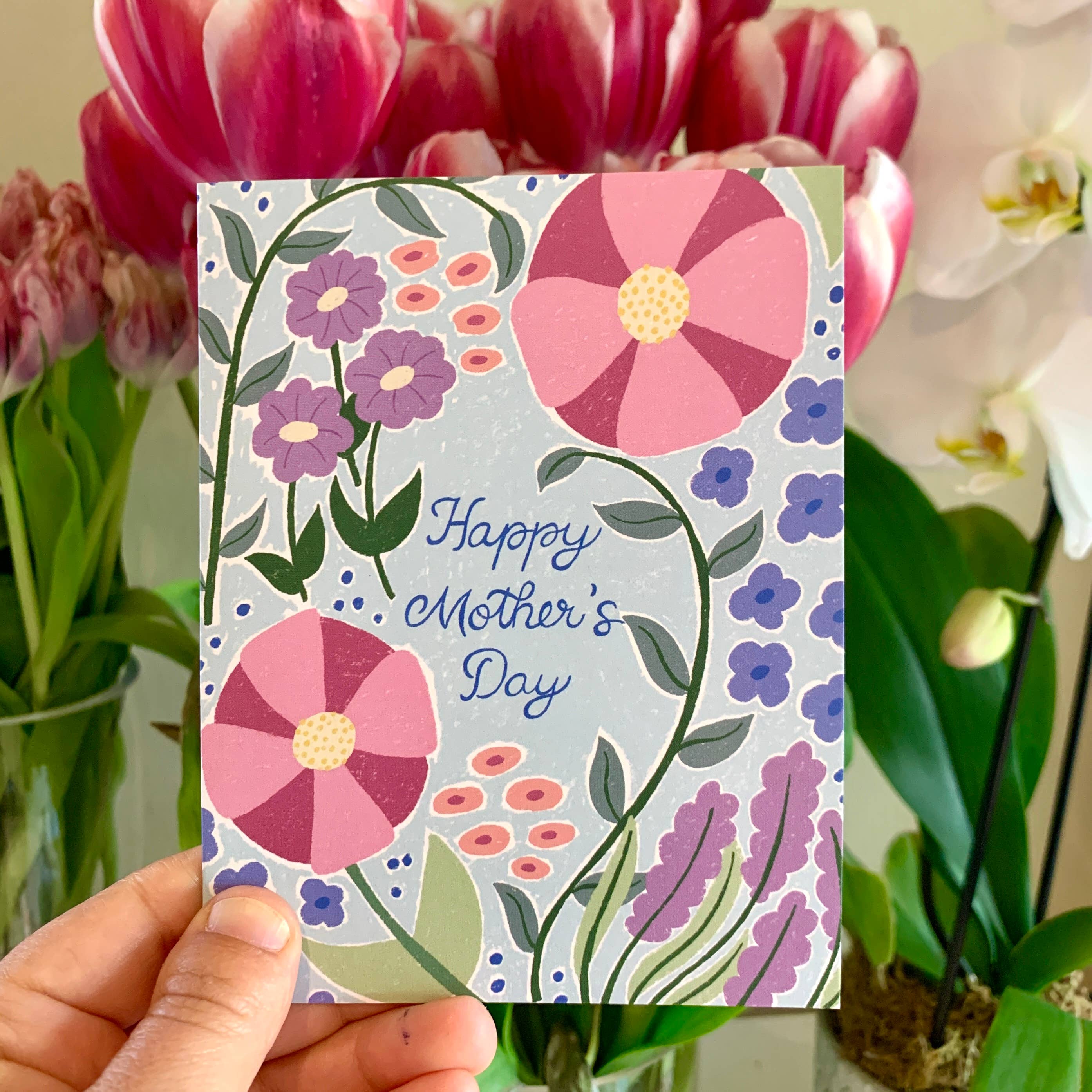 Hand holding a Large Flowers Mothers Day greeting card.