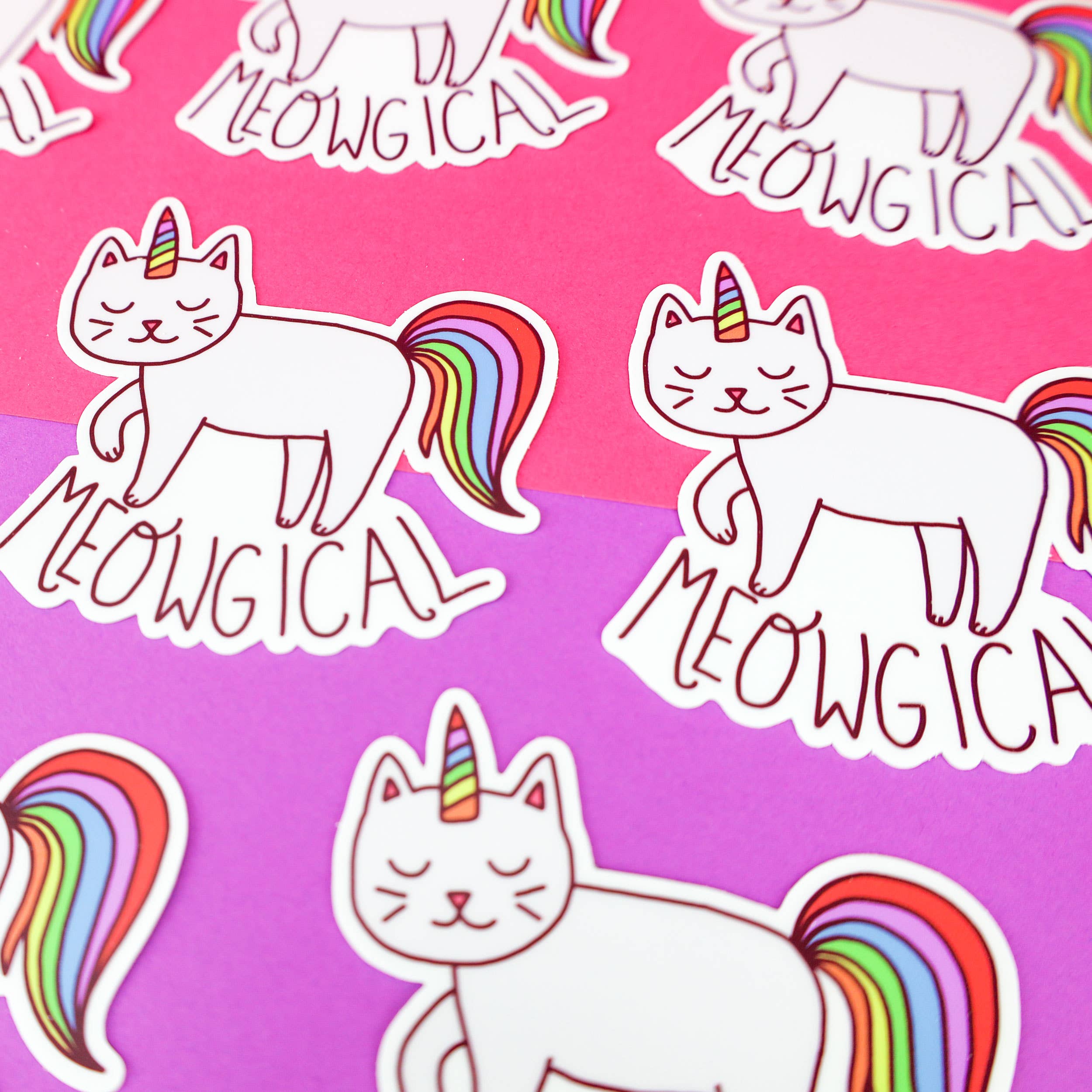 Eco-friendly vinyl sticker featuring unicorn cats and Meowgical text on pink and purple backgrounds.