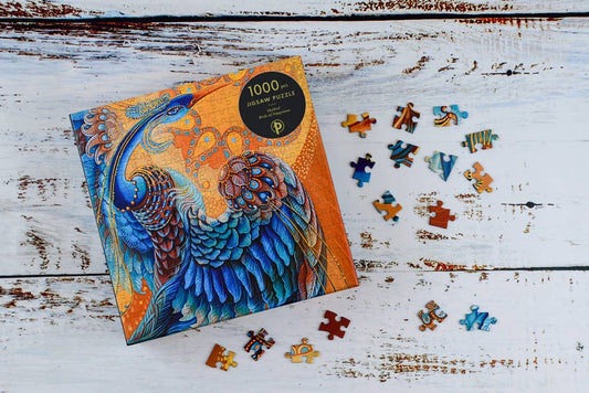 Paperblanks Skybird Birds of Happiness 1000-piece puzzle, blue peacock on white wood, Russian folklore theme.