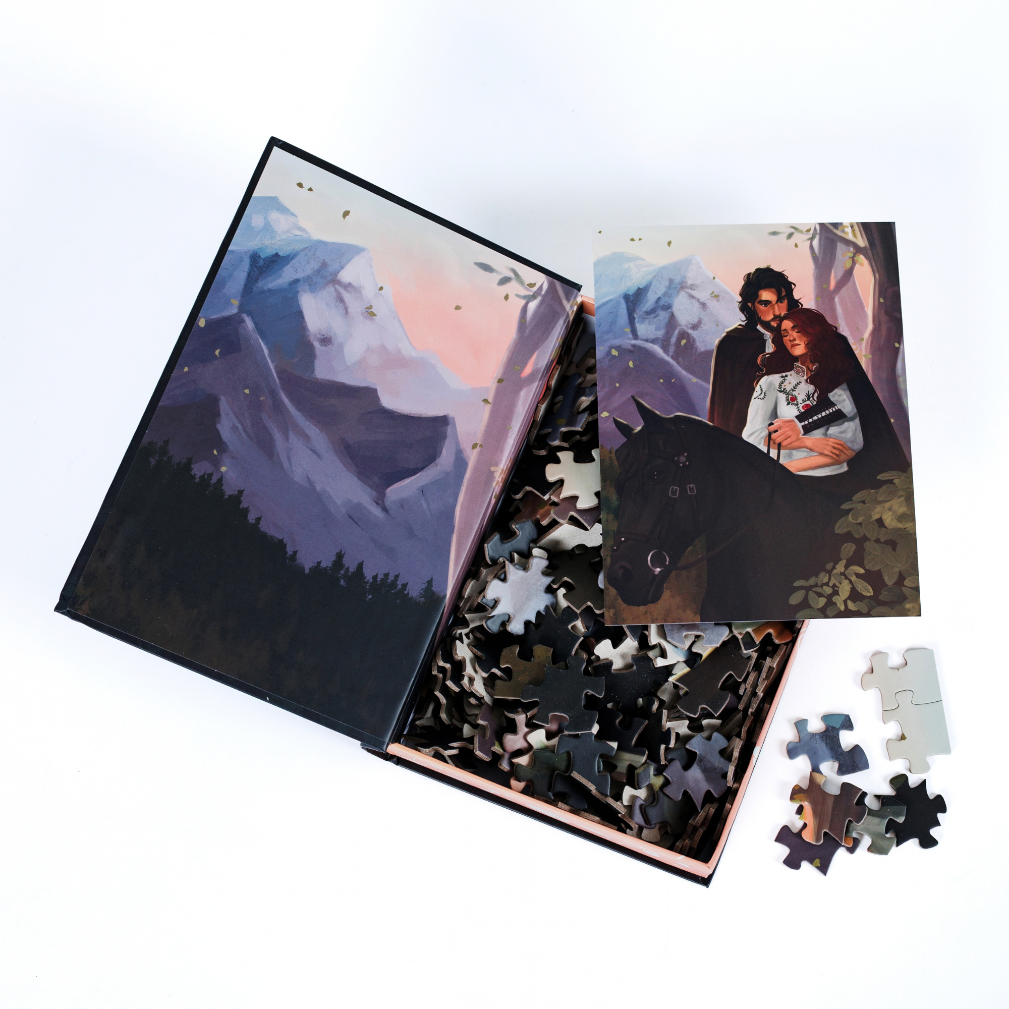 Traveling Through Turah Keepsake Puzzle with Shield of Sparrows pieces in a mountain-themed book-shaped box.