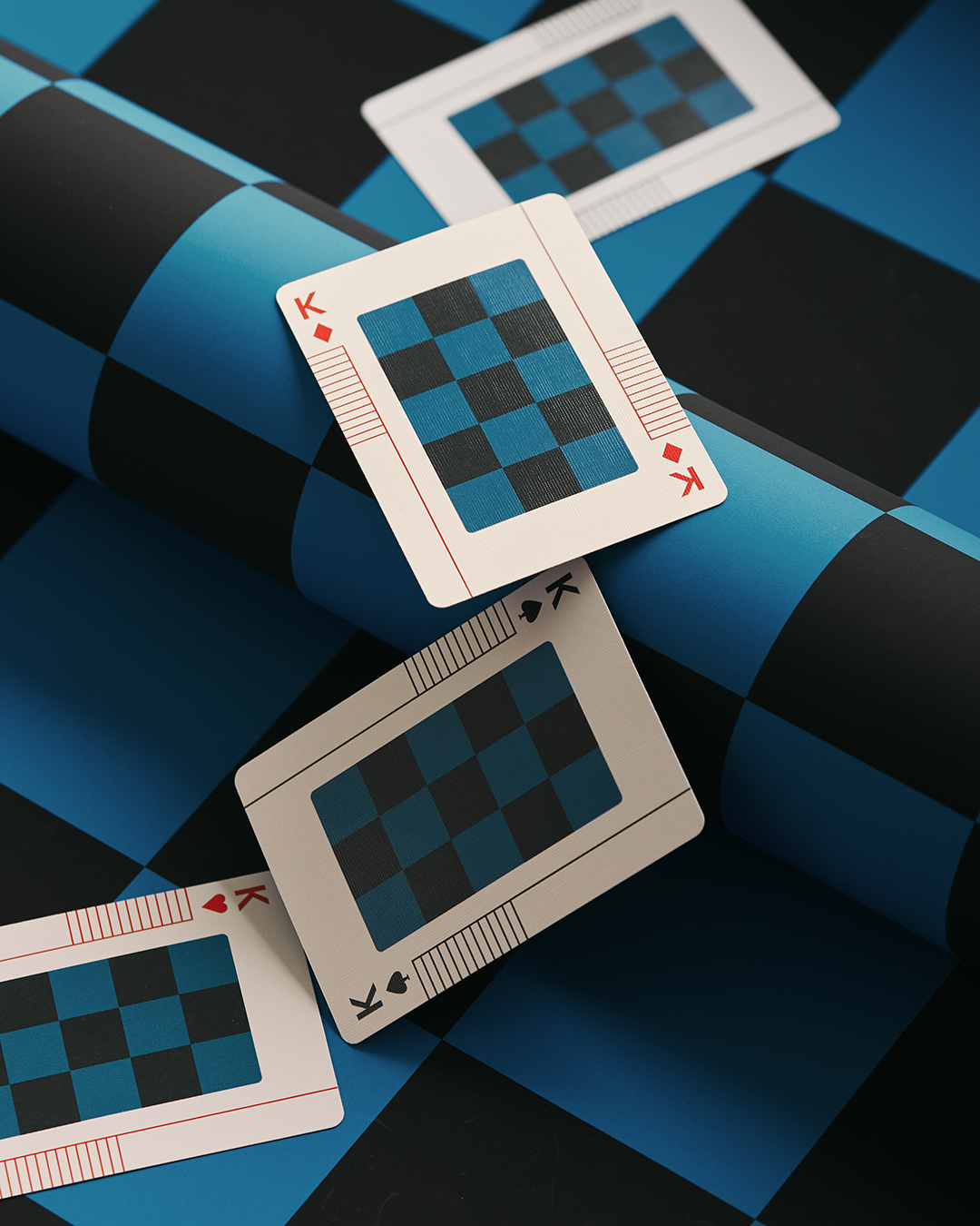 Three Eames The Little Toy playing cards with blue and black checkered patterns.