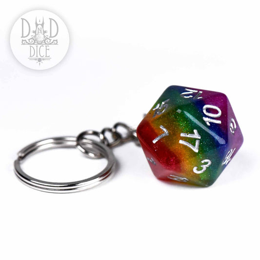 Rainbow D20 keychain with white numbers from DNDDICE.COM shown next to a metal keyring.