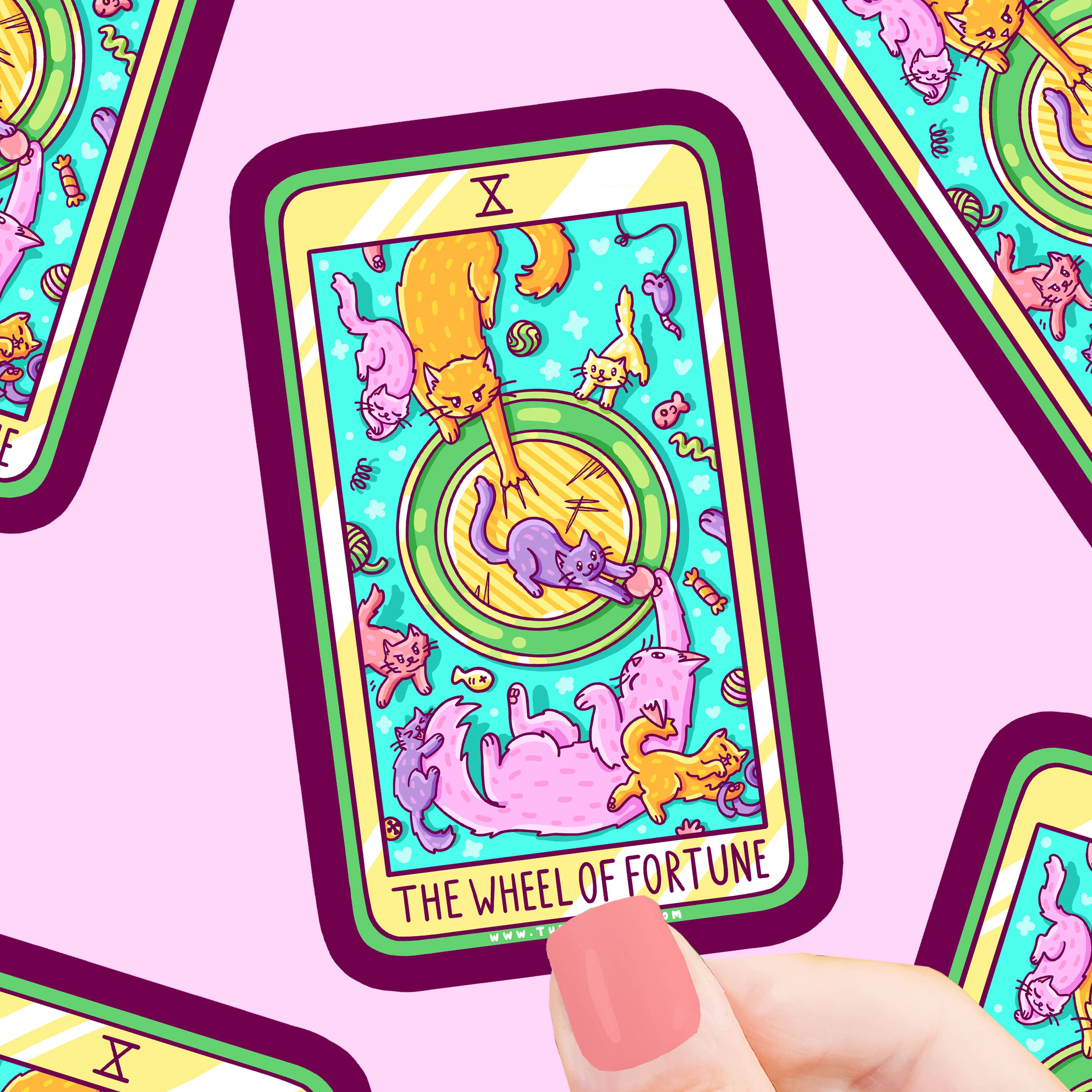 Wheel of Fortune Cat Major Arcana Tarot Card vinyl sticker featuring illustrations of playful cats, held in a hand.