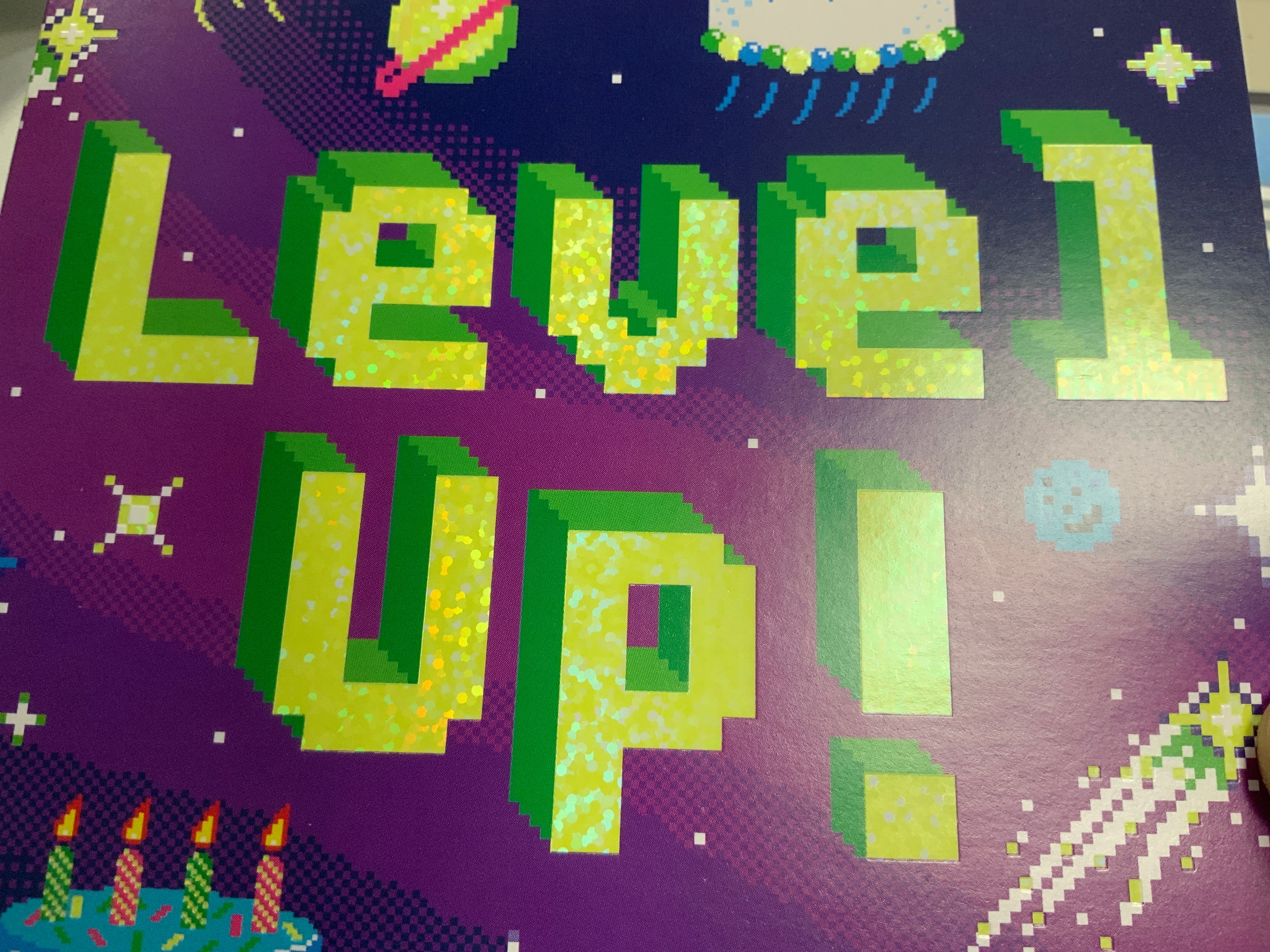 Level Up birthday card with pixel art text on a purple galaxy background with stars and planets.