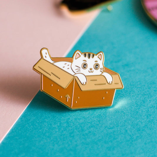 Box Cat Enamel Pin showing a cat sitting inside a box.