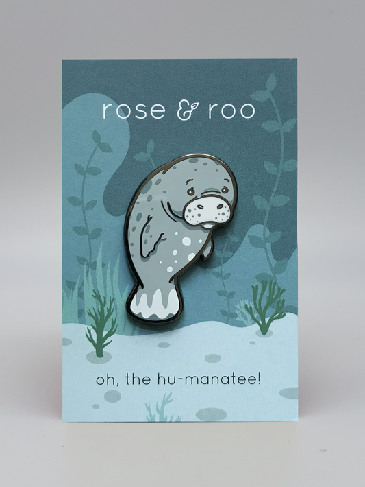 Oh, the Hu-manatee Enamel Pin showing a manatee design; displayed on card with rose & roo and punny text.