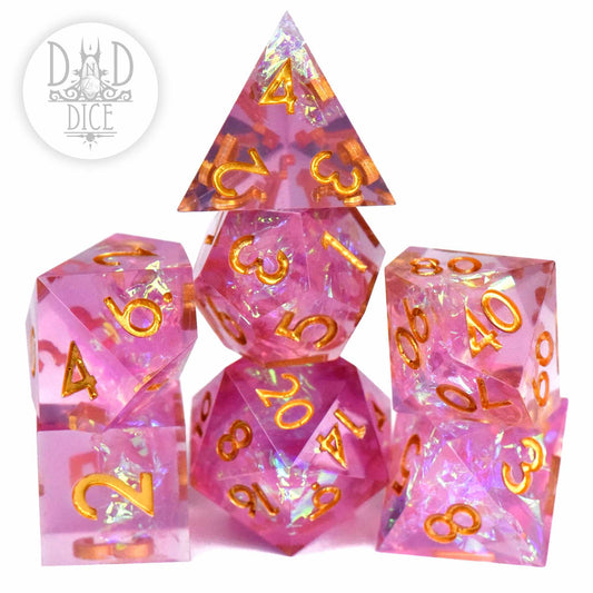 Handmade pink resin polyhedral dice set with gold numbers and iridescent shards, Purifying Light - Color Change variant.