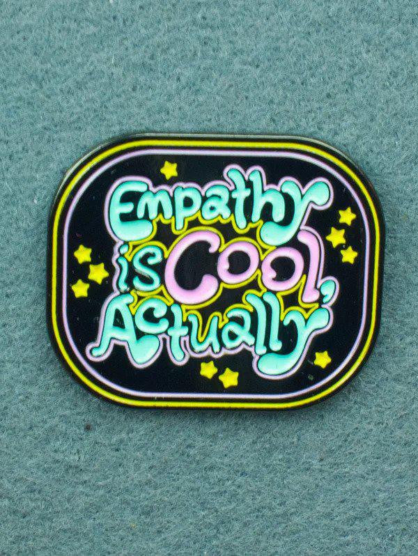 Empathy is Cool soft enamel lapel pin featuring stars on a textured green background.