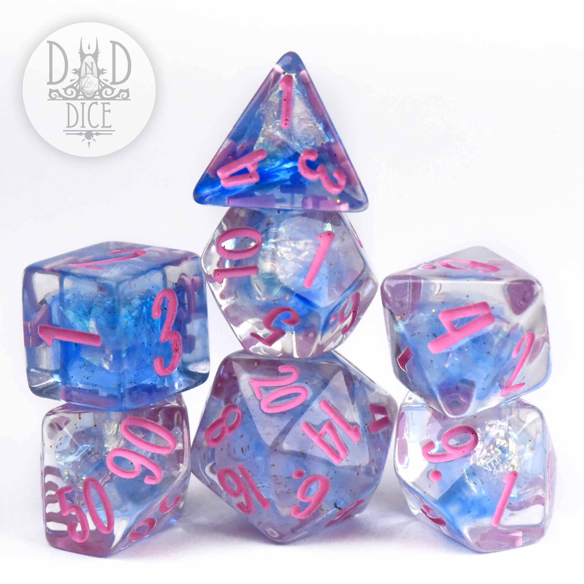 Gossamer Queen 7-piece resin gaming dice set with blue and purple marbled inclusions and pink numbers.