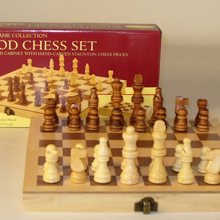 10.5 wood folding chess set with carved pieces on an inlaid board, shown next to its box.