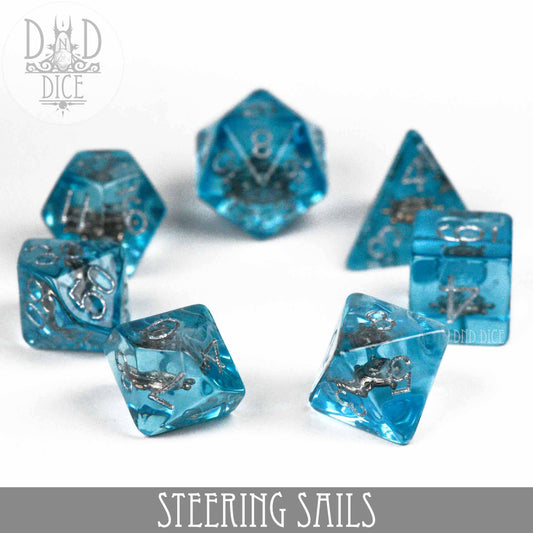 Steering Sails translucent blue resin DND dice set with silver nautical designs inside.