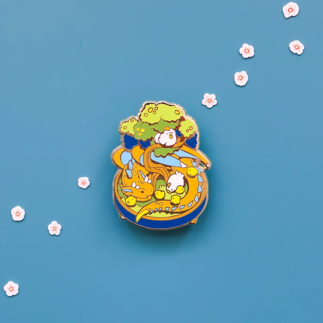 Bonsai Garden-Dragon Enamel Pin showing a dragon under a tree with white flowers on a blue background.