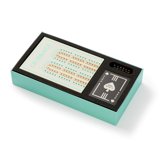 Cribbage in A Box game set with wooden board, playing cards, and pegs in a teal box lined with black foam.