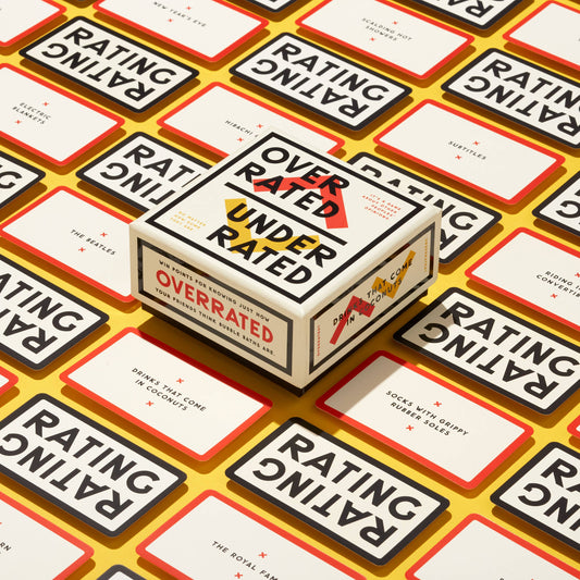 Overrated / Underrated Social Game box with game rating cards on a table.