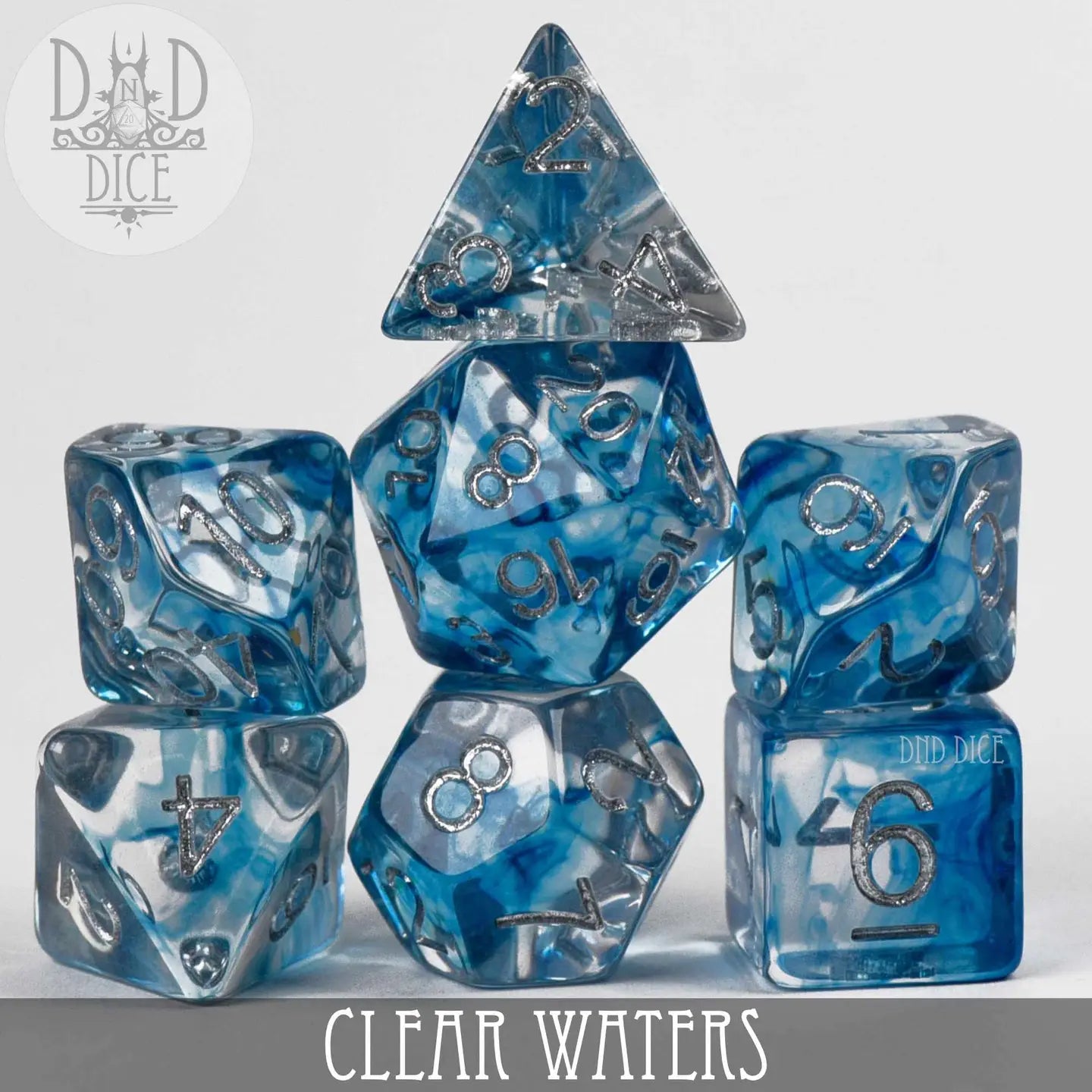 Clear Waters Dice Set: seven blue and clear polyhedral dice with silver numbers.